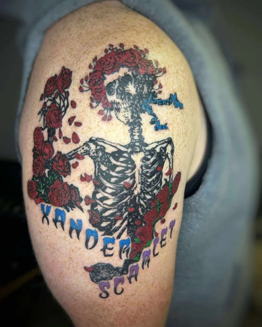 Big Traditional Skeleton With Roses And Skateboard Tattoo on Men Upper Arm by @apothecarytattoos