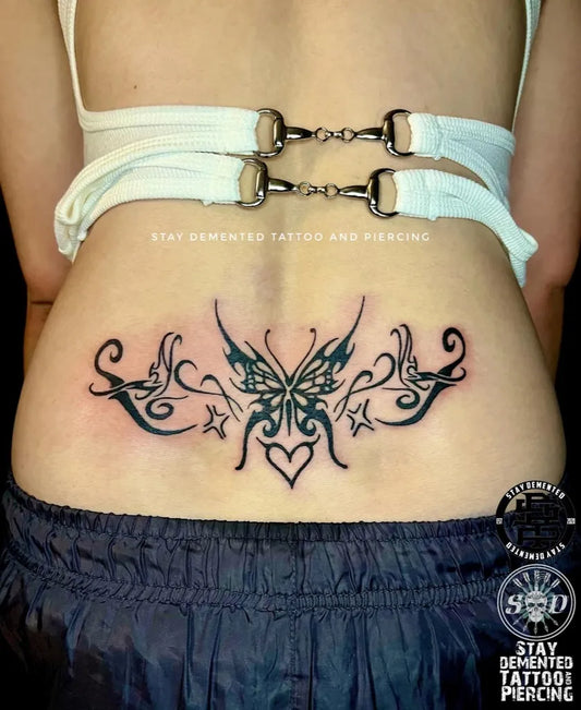 Big Tribal Butterfly Tattoo on Women Lower Back by @staydementedtattooandpiercing
