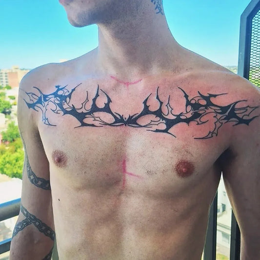 Big Tribal Spiked Wings on Men Chest Tattoo by @laurotatuer