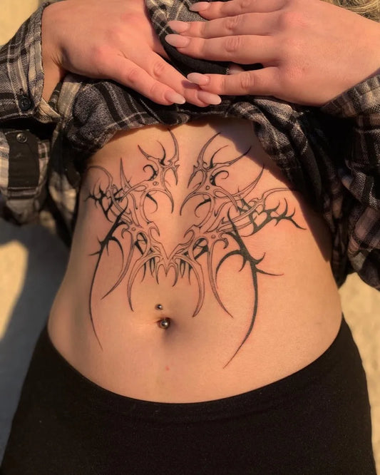 Big Tribal Spikes on Women Sternum Tattoo by @ah.vocado