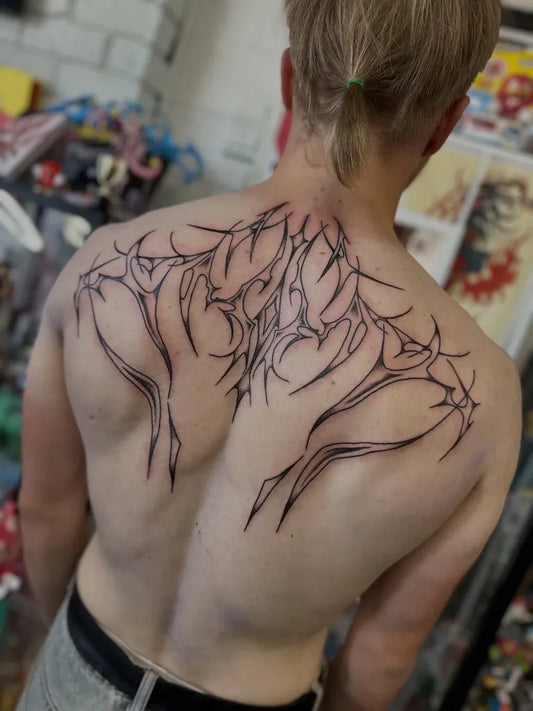 Big Tribal Symmetrical branching vines on Men Back Tattoo by @smitty.tattoo