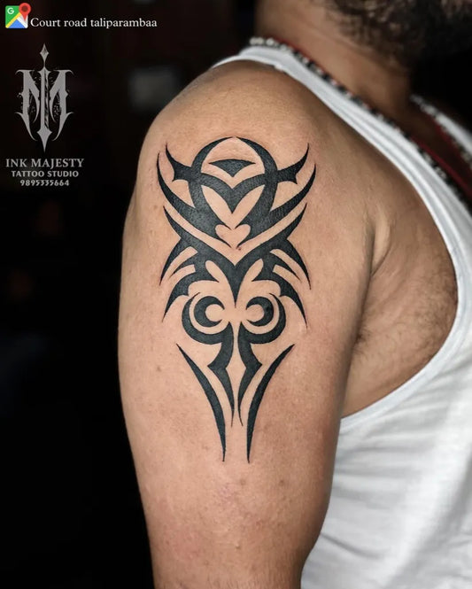 Big Tribal Tribal Heart Symbol on Men Shoulder Tattoo by @inkmajestytattoo