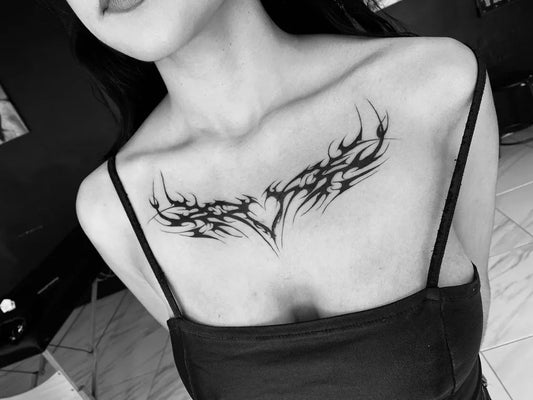 Big Tribal Winged Heart on Women Chest Tattoo by @dafne_zamudio_pierce