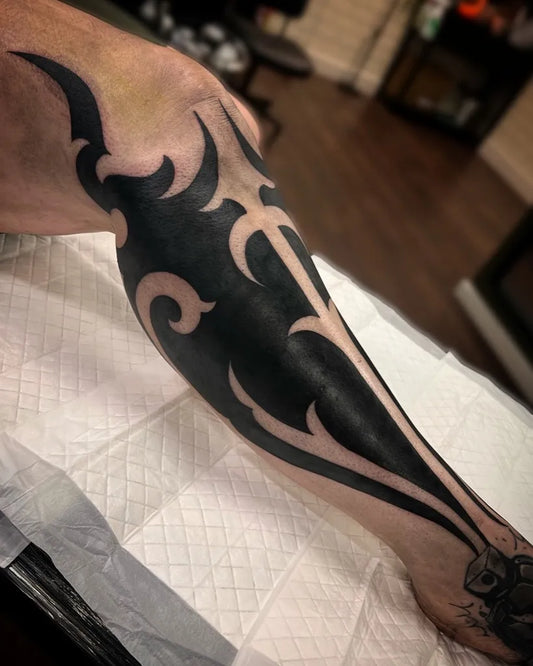 Big Tribal floral tribal patterns spikes on Men Leg Tattoo by @emma.wallistattoo