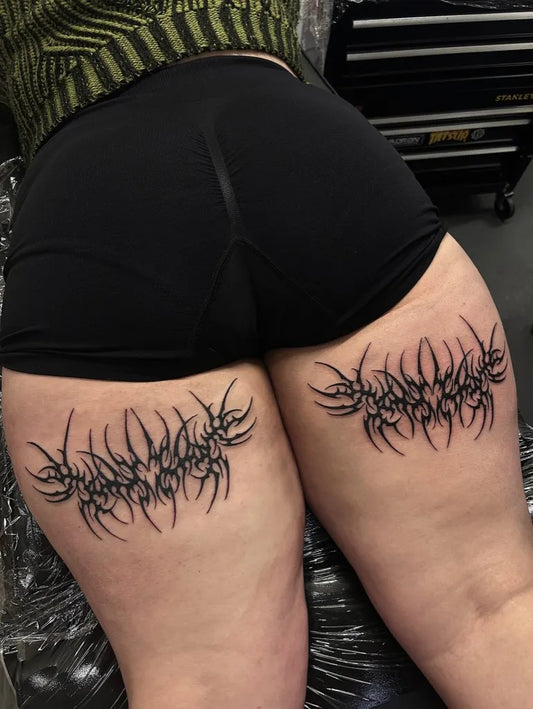 Big Tribal spiky thorns on Women thighs Tattoo by @stabbed.by.cara