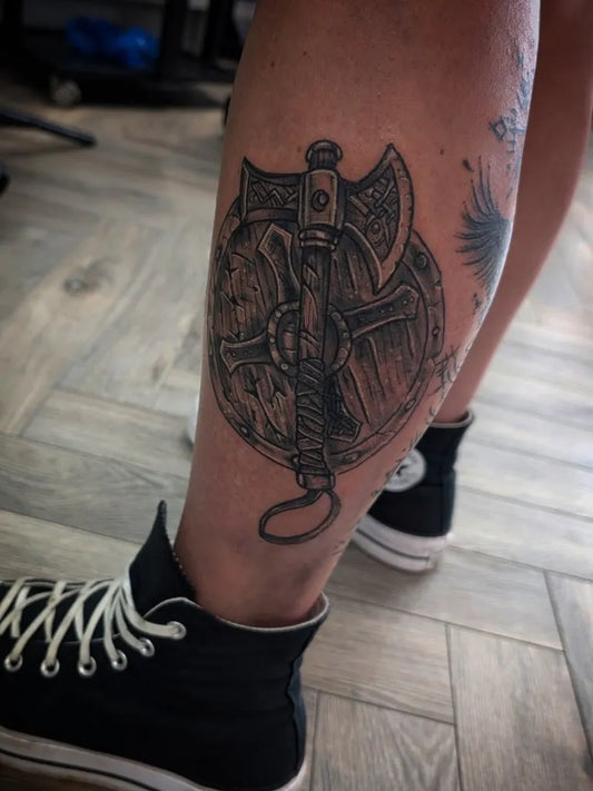 Big Viking Axe and Shield on Men Leg Tattoo by @alex_tattoo_partridge