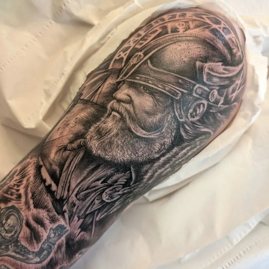 Big Viking Bearded Warrior with Wolf on Men Arm Tattoo by @gentlemangeorgestattooparlour