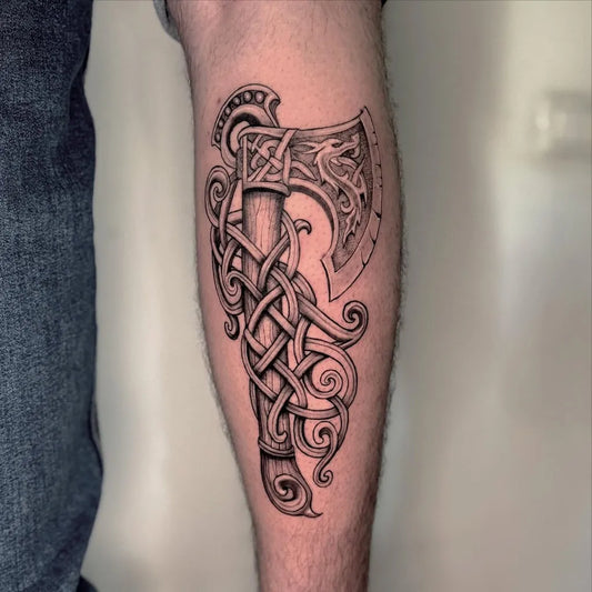Big Viking axe with Celtic knots on Men Arm Tattoo by @ralph.huber.ink