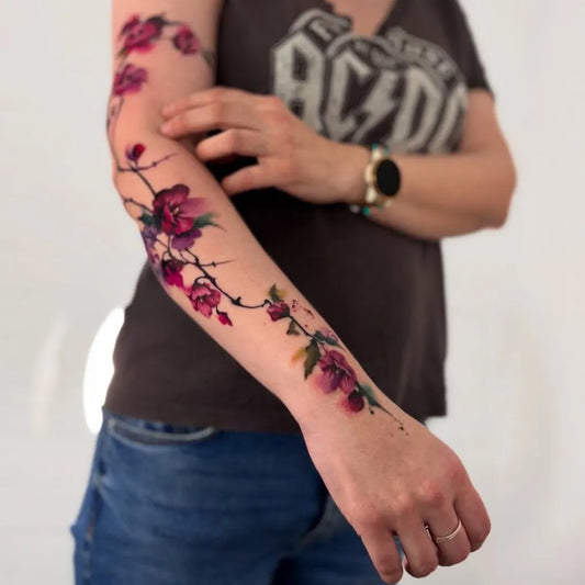 Big Watercolor Cherry Blossom Branches on Women Arm Tattoo by @tattoo_kollektiv