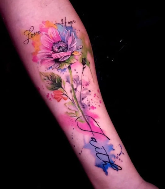 Big Watercolor Daisy with Love and Faith on Women Arm Tattoo by @topsecret.nyc