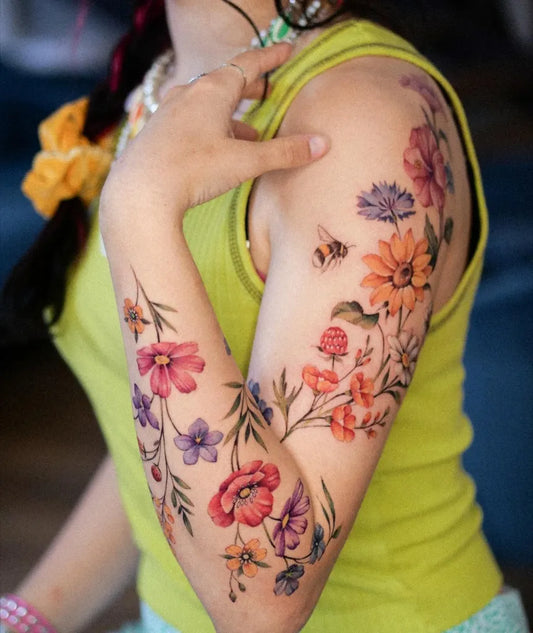 Big Watercolor Flowers and Bee on Women Arm Tattoo by @veroni.ink
