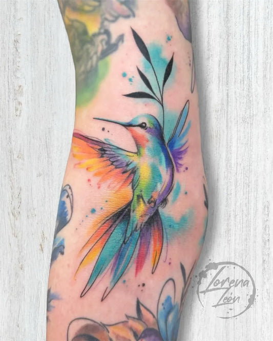 Big Watercolor Hummingbird and Leaves on Women Arm Tattoo by @lorena.leon.tattooart