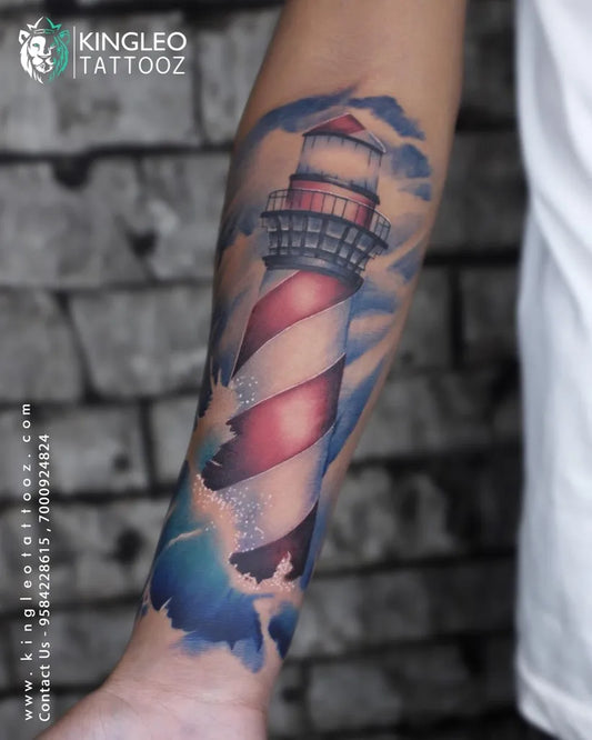 Big Watercolor Lighthouse with Clouds and Waves Tattoo on Men Arm by @kingleo_tattooz