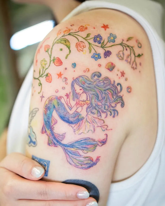Big Watercolor Mermaid with Flowers and Stars Tattoo on Women Shoulder by @dahlia_tattooist