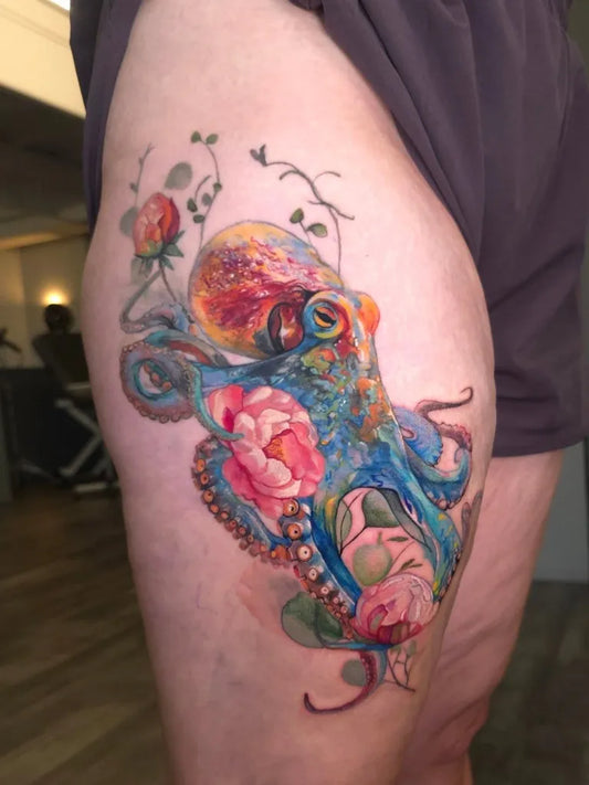 Big Watercolor Octopus and Roses on Women Thigh Tattoo by @tats_and_snacks