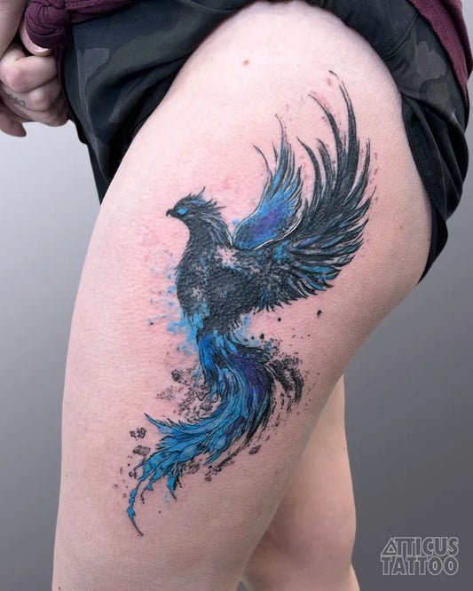 Big Watercolor Phoenix on Women Thigh Tattoo by @atticustattoo