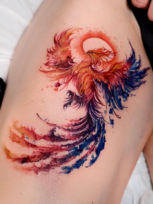 Big Watercolor Phoenix on Women Thigh Tattoo by @suryo.tattoo