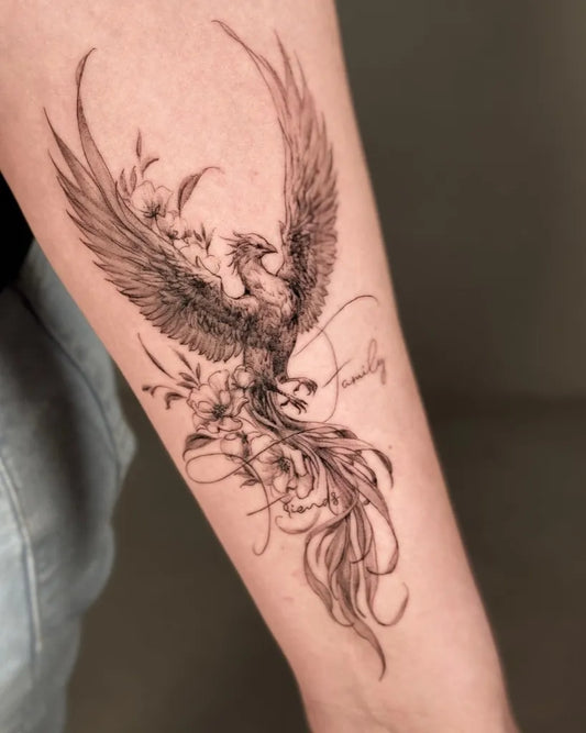 Big Watercolor Phoenix with Flowers and Family Text on Women Arm Tattoo by @vero_creato