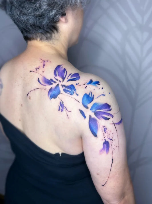 Big Watercolor Purple Flowers on Women Shoulder Tattoo by @michal_y