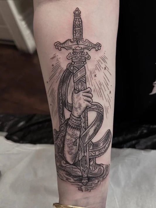Big Woodcut Sword with Hand and Snake on Women Thigh Tattoo by @amberida.tattoo