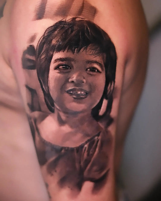 realistic child portrait tattoo