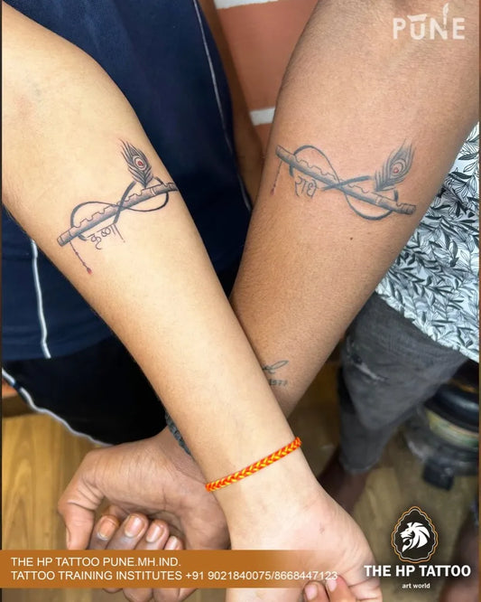 Matching Infinity Peacocks Tattoo on Women Arm by @thehptattoopune