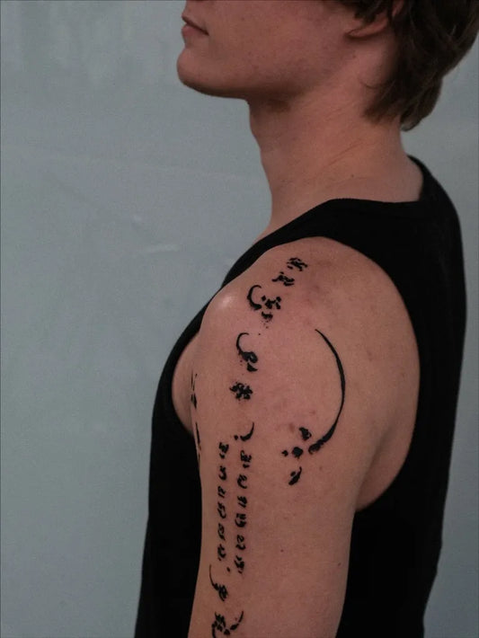 Medium Abstract Script and Crescent Moon Tattoo on Men Shoulder by @waomaoa___tattoo