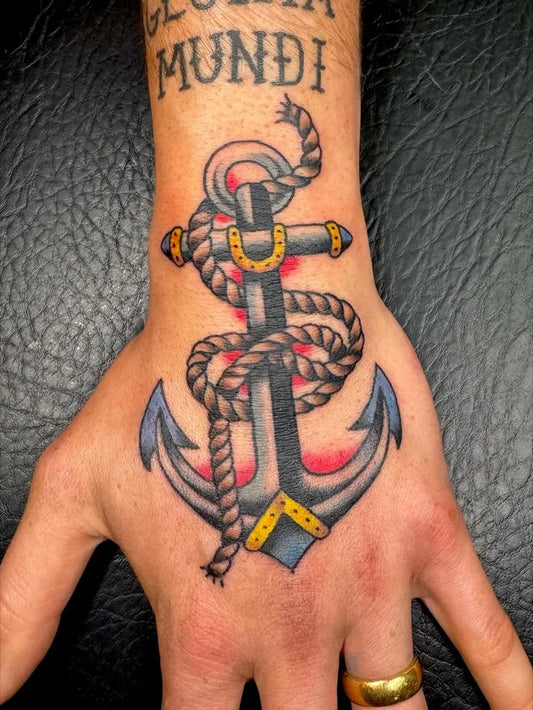 Medium American Traditional Anchor with Rope and Banner Tattoo on Men Wrist by @dust.devil.tatts