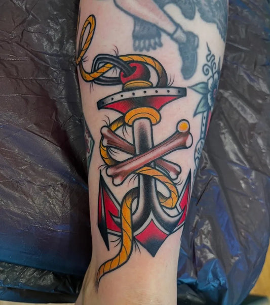 Medium American Traditional Anchor with Rope and Crossbones Tattoo on Men Arm by @danieladventureland