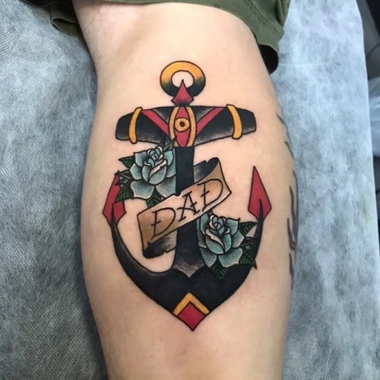 Medium American Traditional Anchor with Roses and Dad Banner Tattoo on Men Leg by @royalrosetattoos