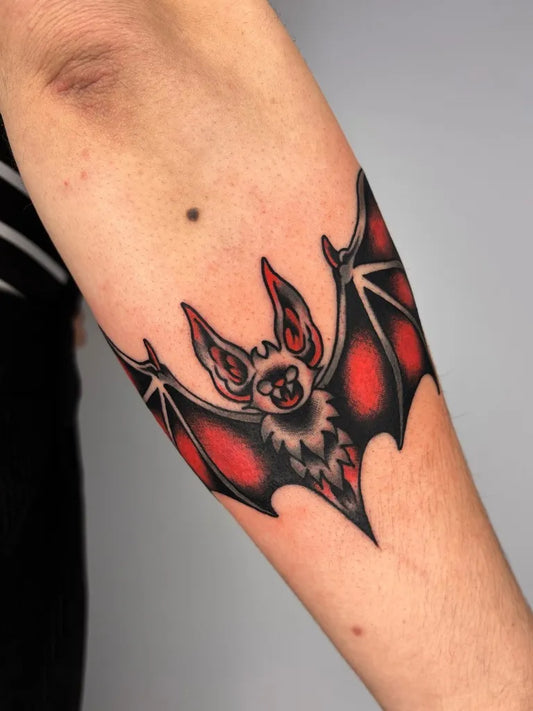 Medium American Traditional Bat Tattoo on Women Arm by @diegocordovatattoo