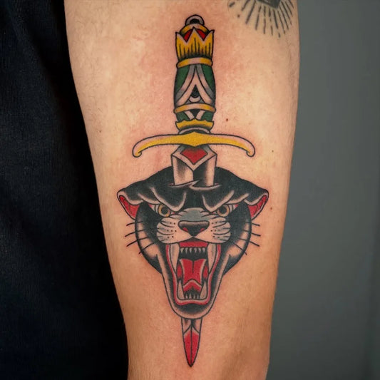 Medium American Traditional Dagger Panther Tattoo on Men Arm by @patriciasullivantattoos