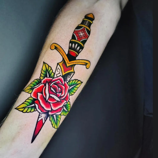 Medium American Traditional Dagger Rose Tattoo on Men Arm by @alteregoknox