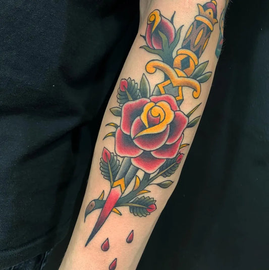 Medium American Traditional Dagger and Rose Tattoo on Men Arm by @stos_tattoos