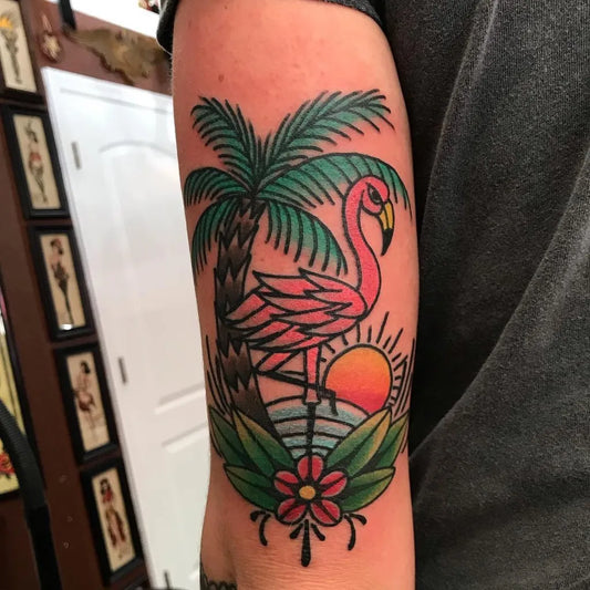 Medium American Traditional Flamingo Palm Tree Sun Tattoo on Men Arm by @bludshaker
