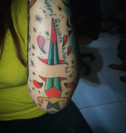 Medium American Traditional Knife with Banner and Stars Tattoo on Women Arm by @jauwatattoostudioo