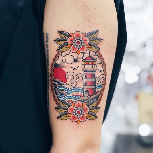 Medium American Traditional Lighthouse and Flowers Tattoo on Men Arm by @ngaiiijun