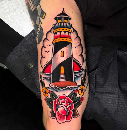 Medium American Traditional Lighthouse and Rose Tattoo on Men Thigh by @valentina.avati