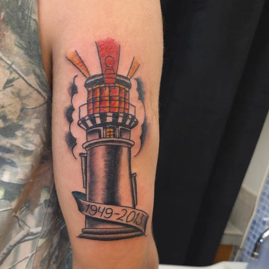 Medium American Traditional Lighthouse with Banner Men Arm Nautical Tattoo on Men Arm by @freaksandgeekstattoo