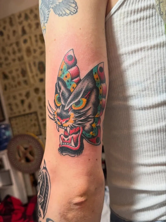 Medium American Traditional Panther Butterfly Tattoo on Men Arm by @thecrocster