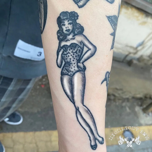 Medium American Traditional Pin Up Girl Tattoo on Women Arm by @highlight_ink