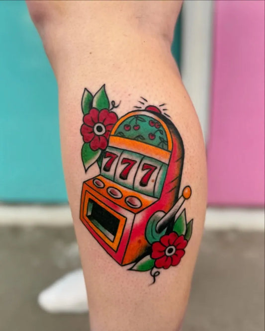 Medium American Traditional Slot Machine with 777 and Flowers Tattoo on Women Leg by @inkbymasynn