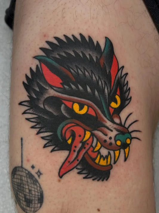Medium American Traditional Wolf on Men Arm Tattoo by @carolantattoo