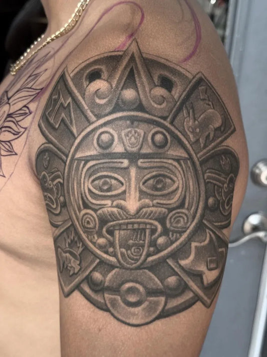 Medium Aztec Sun Stone Face Tattoo on Men Shoulder by @nahualli.iink