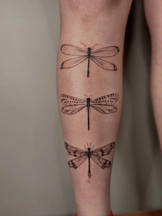Medium Black and Grey 3 Dragonflies on Women Leg Tattoo by @inkbyjustice