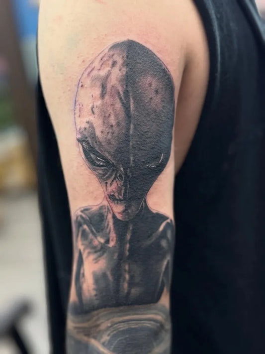 Medium Black and Grey Alien Head Tattoo on Men Arm by @goode_ink