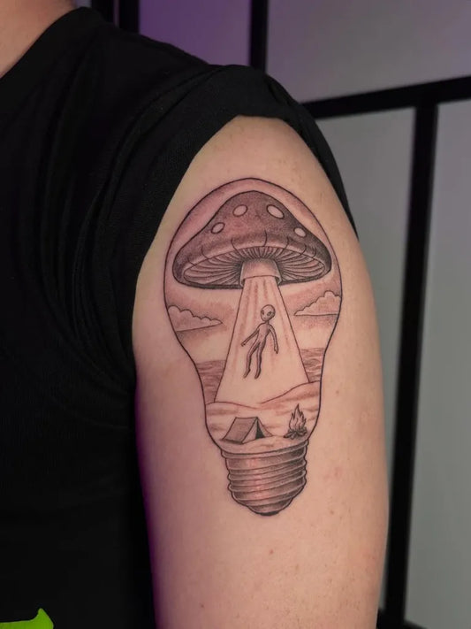 Medium Black and Grey Alien Mushroom Lightbulb Tattoo on Men Upper Arm by @caswelltattoos