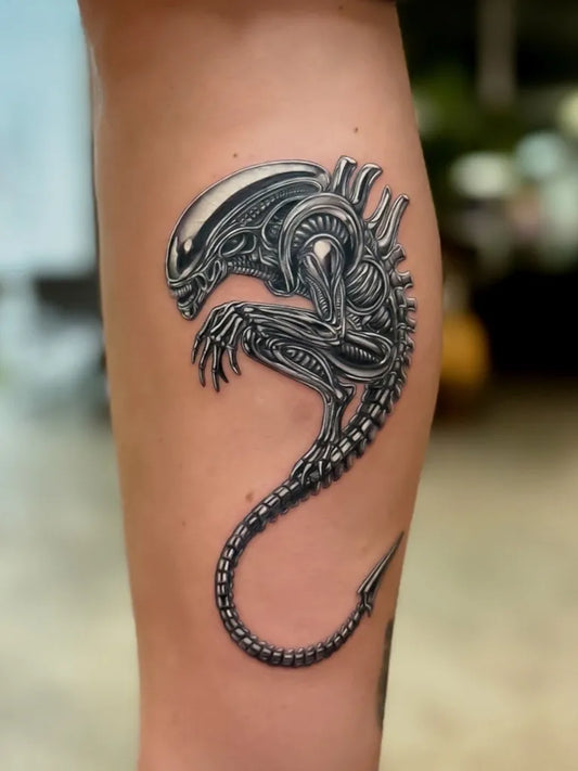 Medium Black and Grey Alien Tattoo on Men Leg by @nicotattoo.nyc