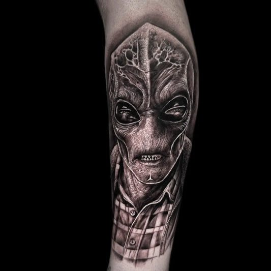 Medium Black and Grey Alien in Plaid Shirt Tattoo on Men Arm by @revivaltattoostudio