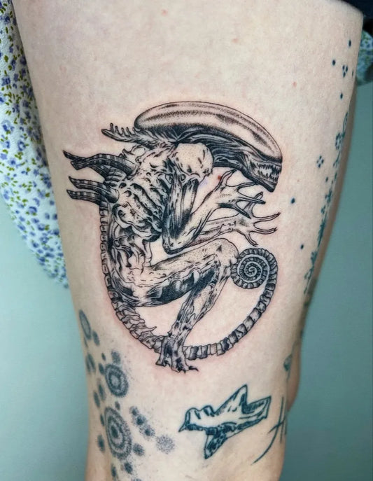 Medium Black and Grey Alien with Tail and Bird Tattoo on Women Thigh by @tatsbymavs